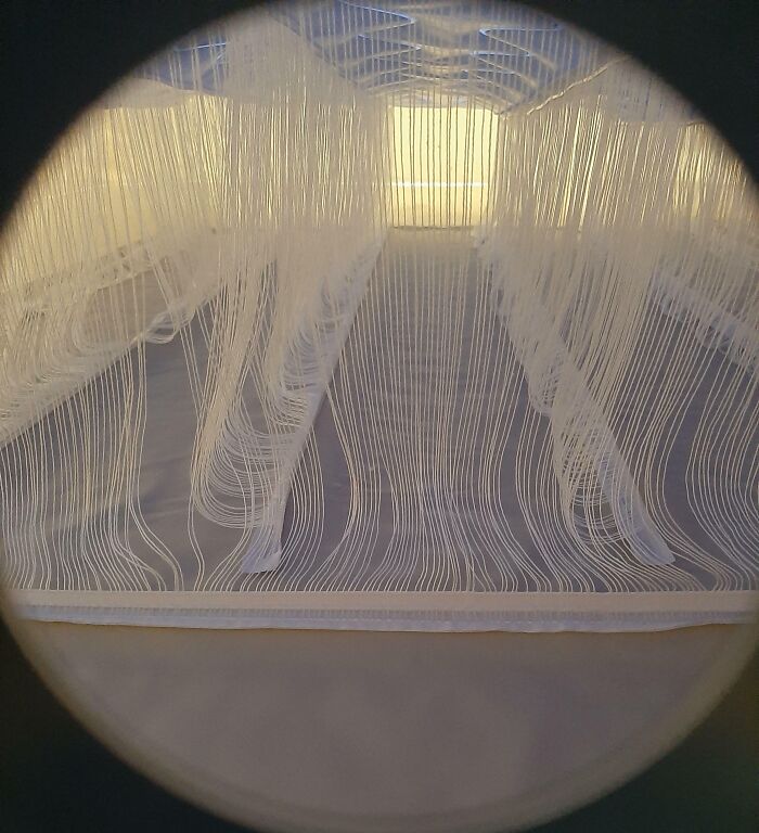 Microscopic image showing fine threads and fibers giving a unique perspective of ordinary textile material details.