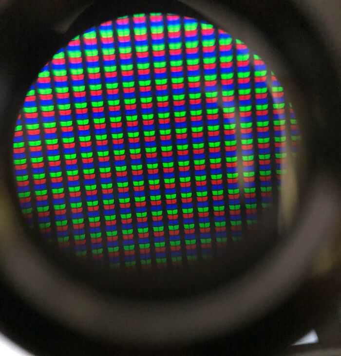 Microscopic image showing a close-up view of RGB pixels in a digital screen with vibrant colors and sharp details.