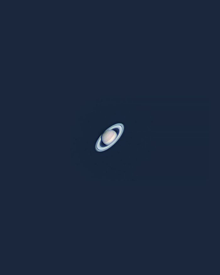 Clear telescope image of Saturn with its rings against a dark sky, showcasing one of the most unreal photographs.