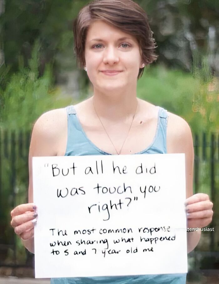 Young woman holding a sign highlighting a common response to sharing childhood a***e, addressing misogynist attitudes.