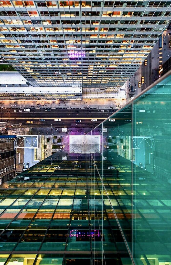 Aerial view of city street and illuminated skyscrapers showcasing unreal photographs of urban architecture.