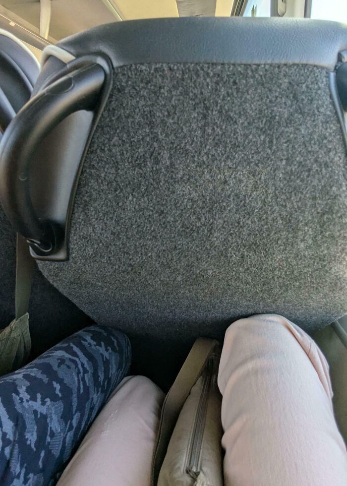 Legroom invasion by public transport passengers showing cramped and uncomfortable seating on crowded bus or train.