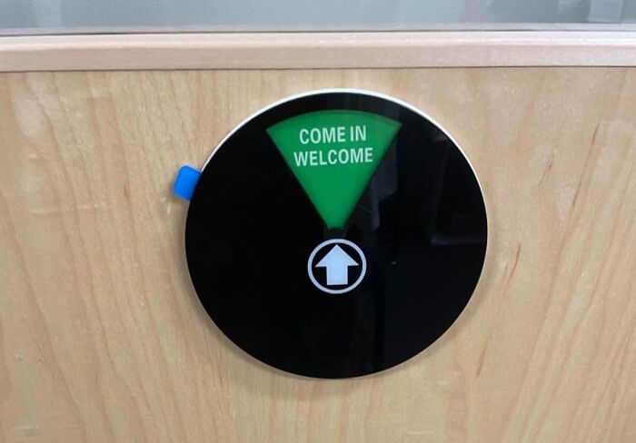 Round office door indicator showing "Come In Welcome" on a green section, part of quirky office supplies collection.