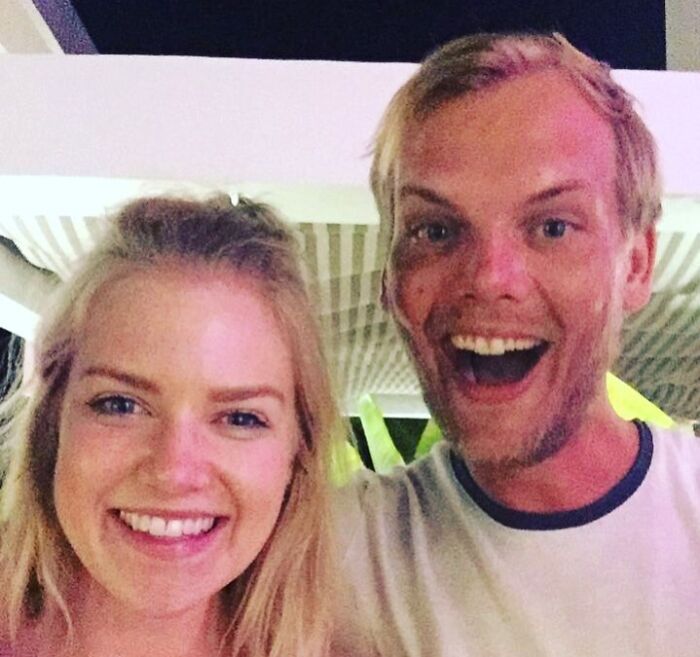 Smiling man and woman taking a selfie together outdoors, featured in last known photos of famous people collection.