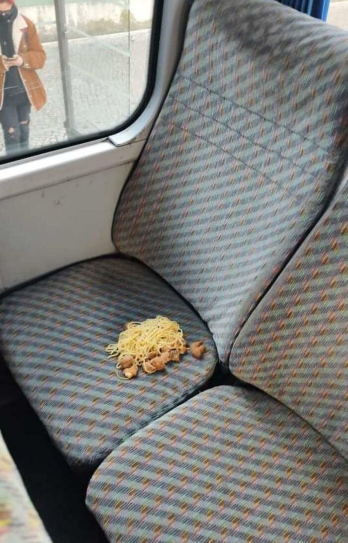 Unattended pile of noodles and meat left on a public transport seat showing infuriating passenger behavior.