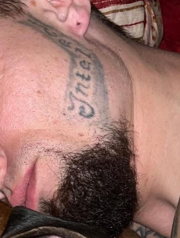 Close-up of a man's face with a poorly designed face tattoo, illustrating hilariously bad tattoos and inkshaming.