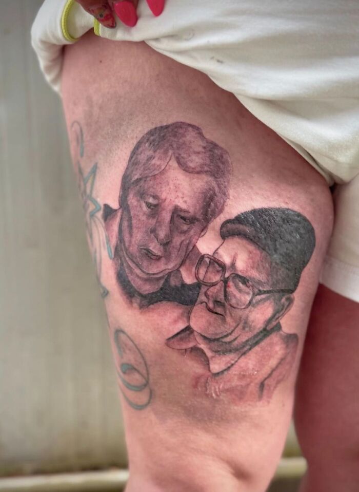 Tattoo on thigh showing two poorly drawn faces, an example of hilariously bad tattoos and inkshaming moments.