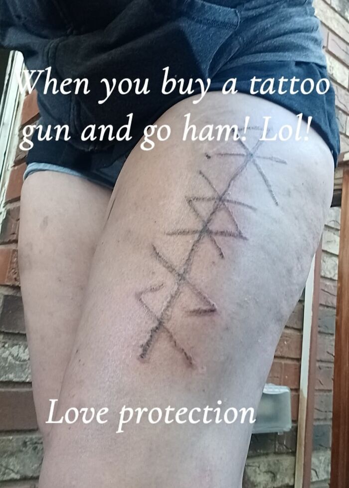 Close-up of a hilariously bad tattoo on a leg showing a crude design with text about love protection and tattoo fails.