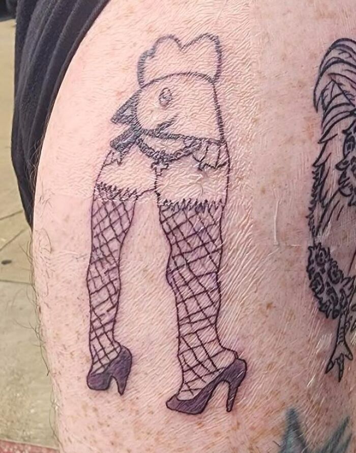 Tattoo of a chicken with human legs in fishnet stockings and high heels, showcasing a hilariously bad tattoo design.