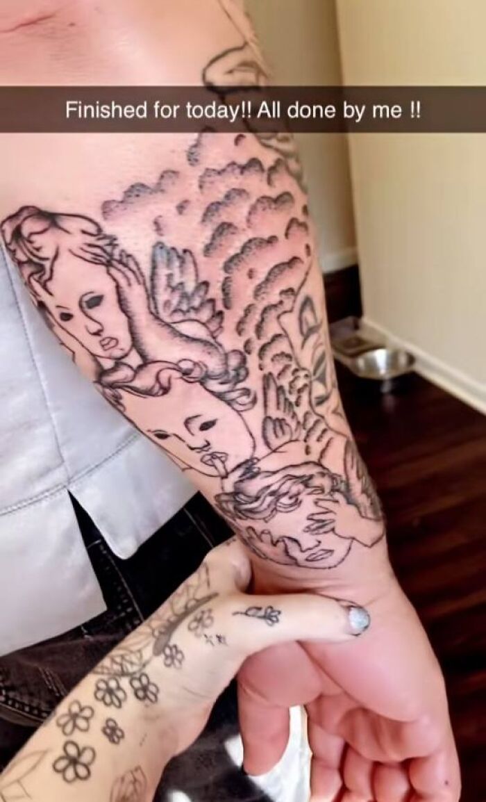 Arm tattoo with poorly drawn angel faces and wings, an example of hilariously bad tattoos from inkshaming posts.