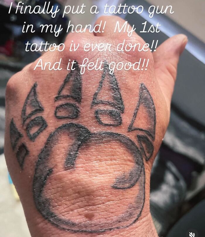 Hand tattoo of a poorly drawn paw print, an example of hilariously bad tattoos in inkshaming fails.