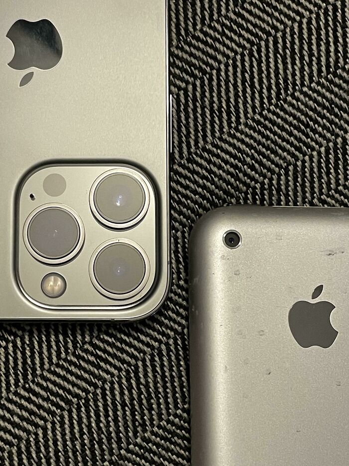 Comparison pic of two Apple iPhones placed side by side, highlighting variety in phone camera designs and features.