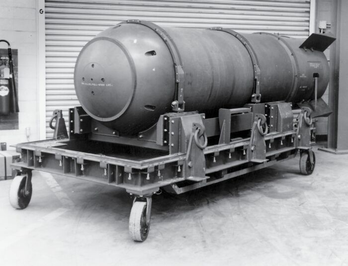 Historic b**b on wheeled cart in a storage facility, representing lesser-known historical events and artifacts.