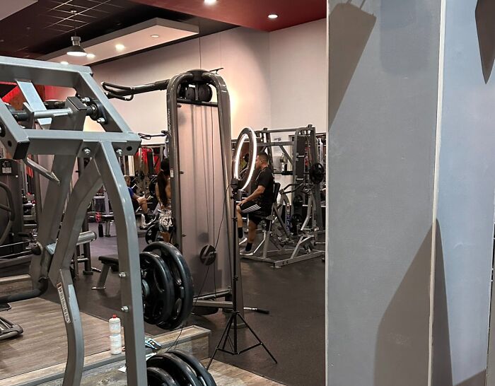 Gym equipment and people exercising, illustrating common annoying gym moments that challenge workouts and motivation.