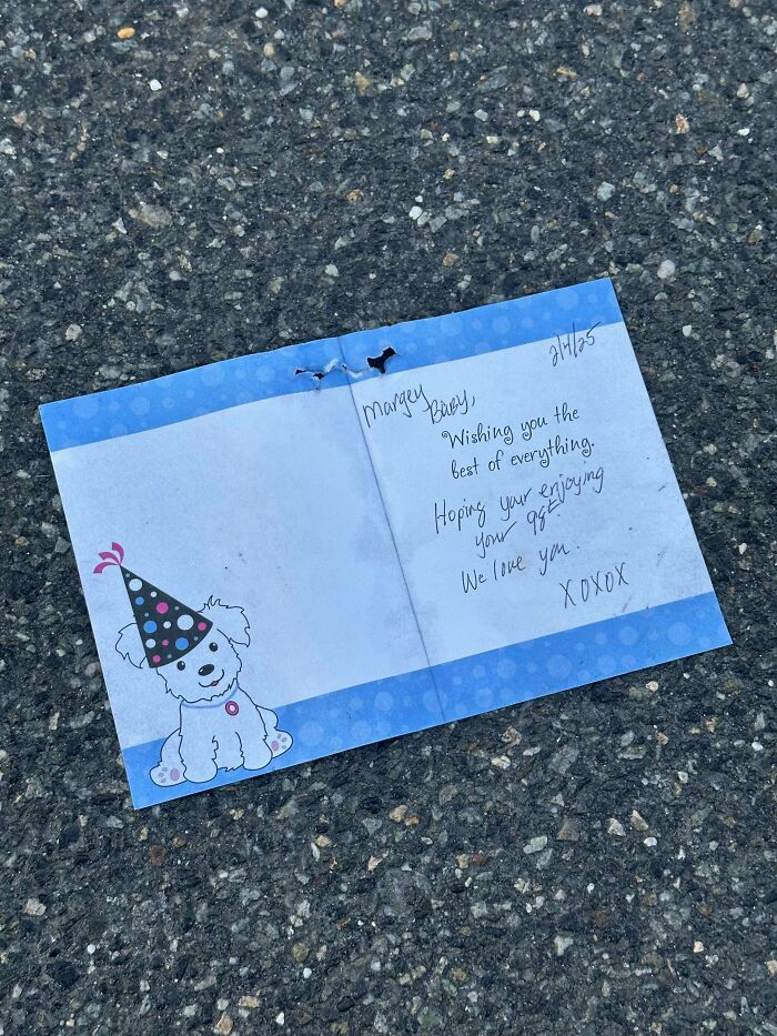 Handwritten note on blue paper with a cartoon dog party hat, one of 80 historical mementos people randomly found.