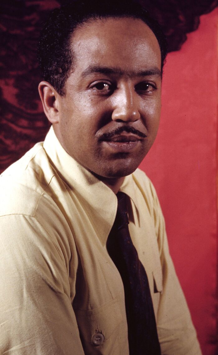Portrait of a Harlem Renaissance figure in a yellow shirt and dark tie, representing crucial moments of the era.