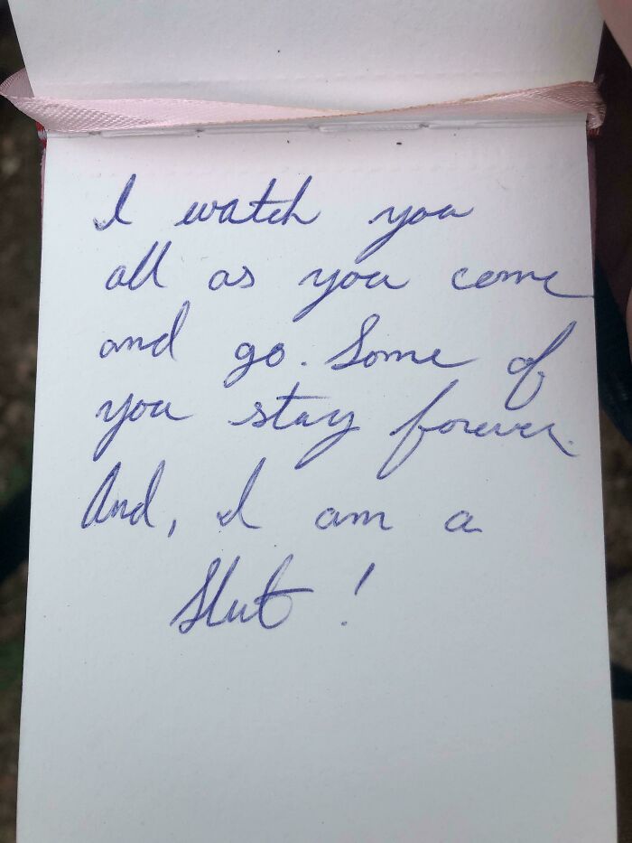 Handwritten note found among historical mementos, featuring a personal message written in blue ink on white paper.