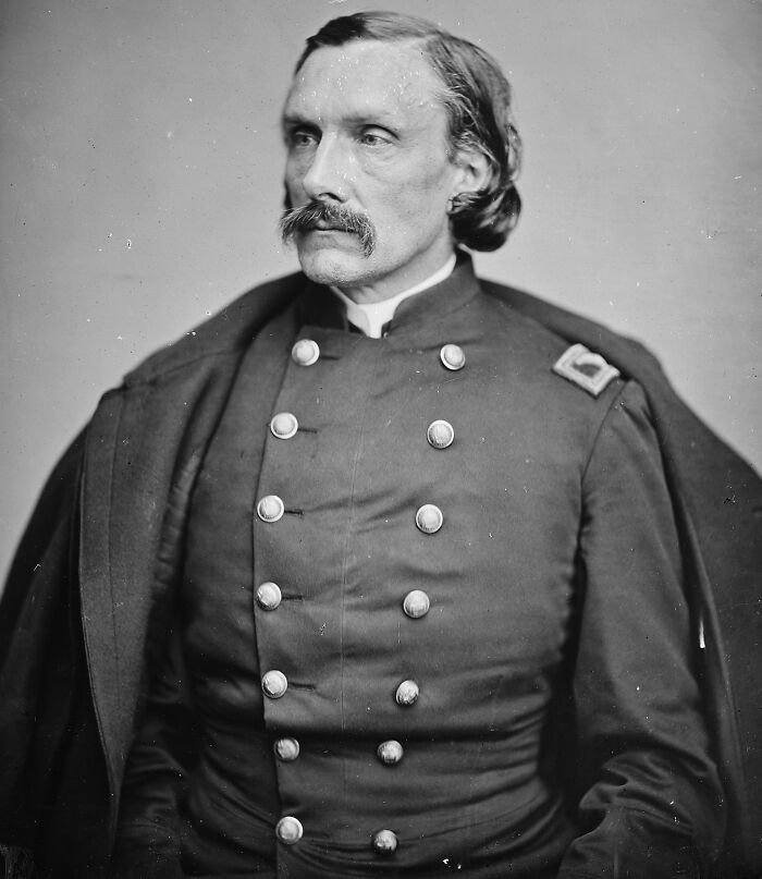 Black and white portrait of a 19th-century military officer in uniform, representing overlooked historical events.