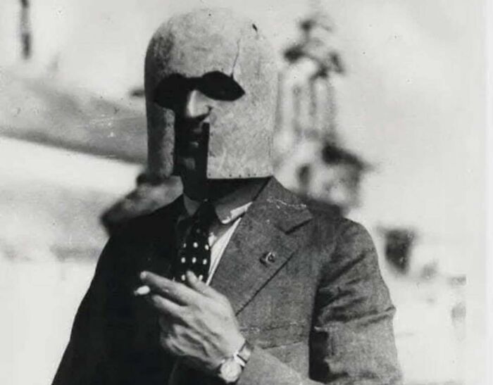 Man in vintage suit wearing a strange medieval helmet, representing weird things about history on Instagram account.