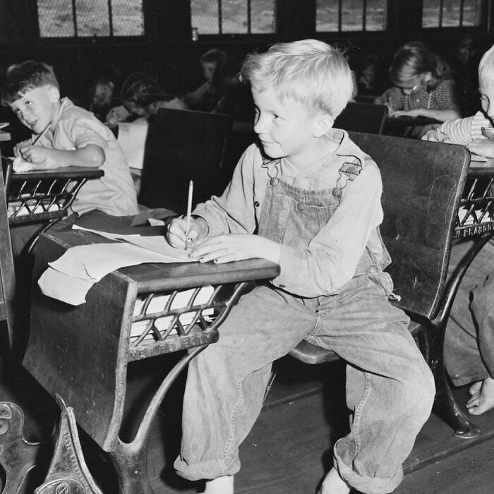 Black and white photo of children writing in a classroom, illustrating weird things about history on an Instagram account.