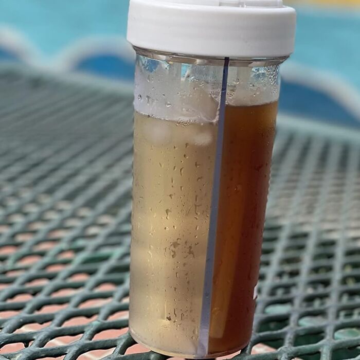 Dual-compartment beverage container with ice and two different drinks, showcasing multi-tasking marvels for your home.