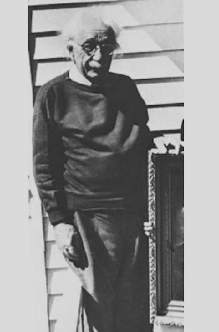 Black and white photo of an elderly famous person standing outside, one of the last known photos of famous people.