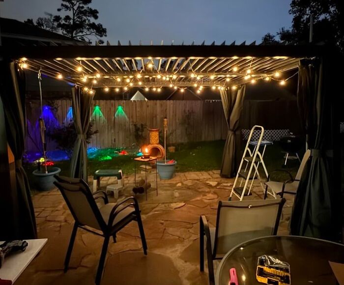Backyard patio setup at night with string lights and seating, perfect for July 4th parties and outdoor gatherings.
