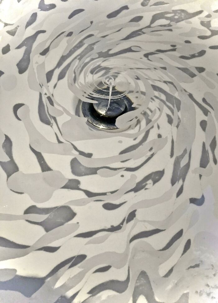Swirling shadow patterns around a sink drain creating a cool and interesting effect that made people look twice.