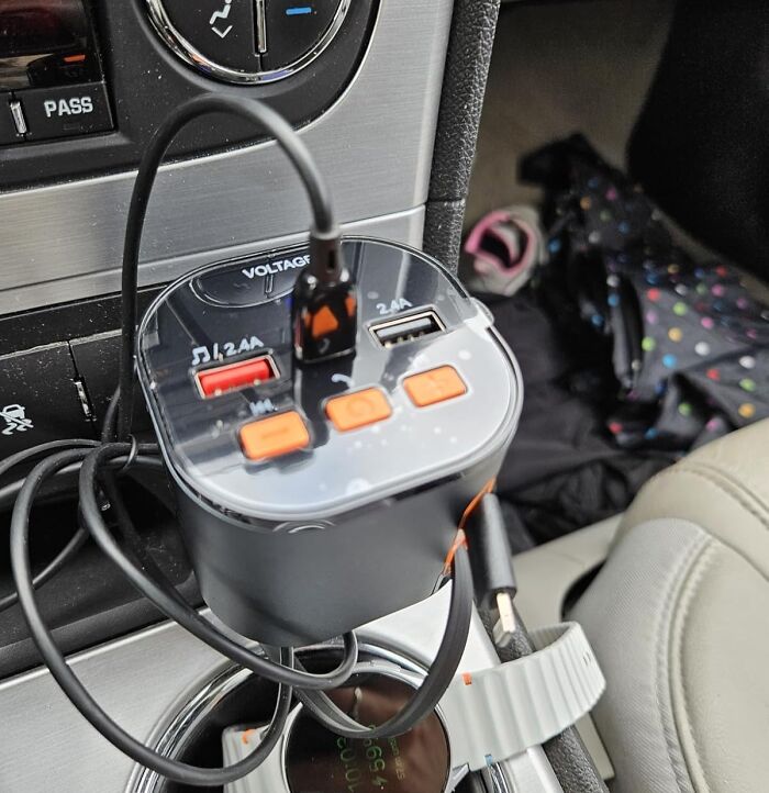 Car charger with multiple USB ports and orange control buttons, showcasing multi-tasking marvels for your home and travel.