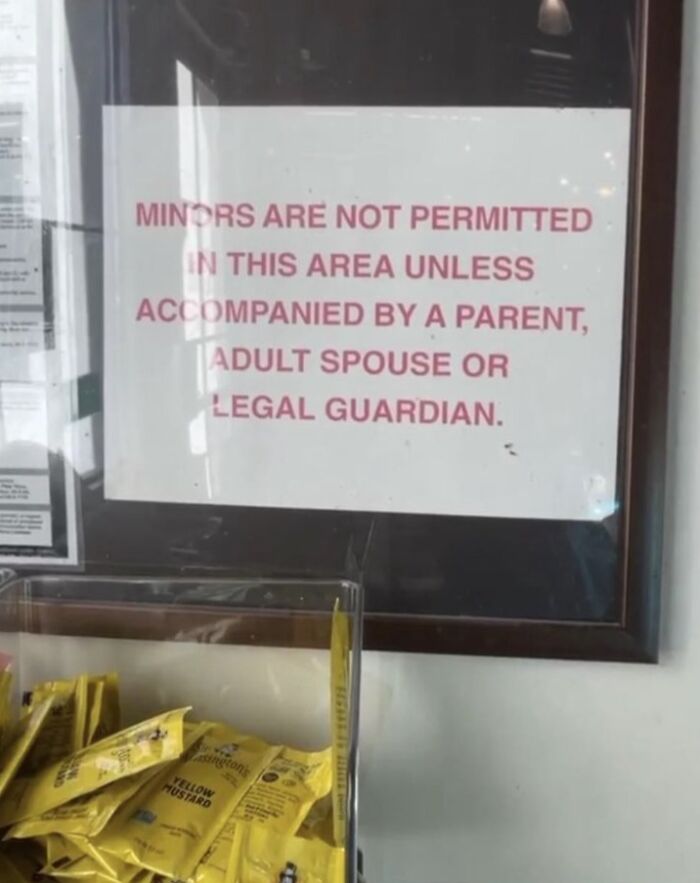 Sign stating minors not permitted without adult supervision, highlighting concerns about traumatizing the next generation concept.