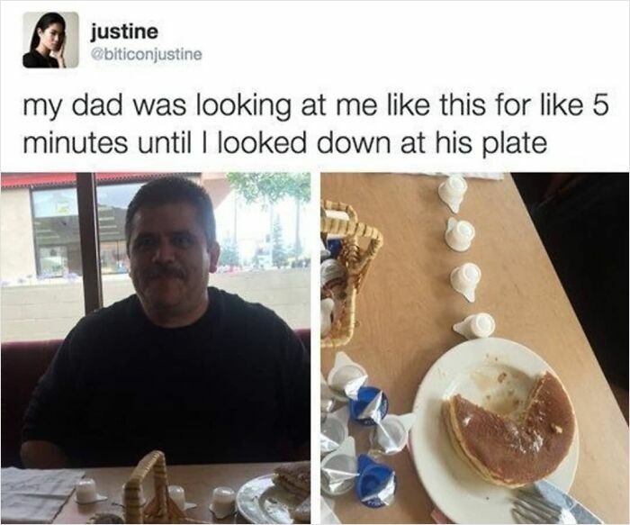 Man looking lovingly across the table at a heart-shaped pancake with coffee creamer cups on a wooden table.