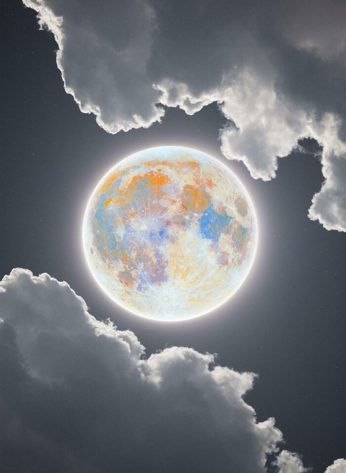 Unreal photograph of a brightly glowing, multi-colored moon partially obscured by dark clouds in night sky.