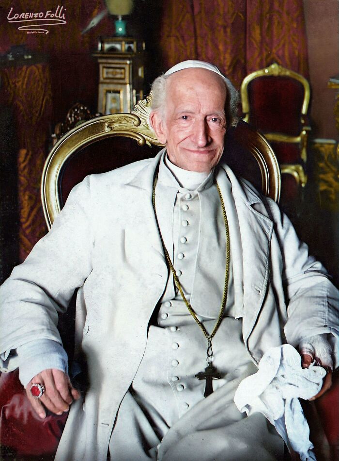 Colorized portrait of an elderly man in religious attire sitting on an ornate chair in an elegant historical setting.