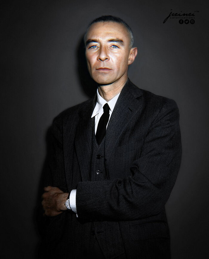 Colorized history photo of a serious man in a suit with blue eyes, showcasing interesting colorized history pics style.