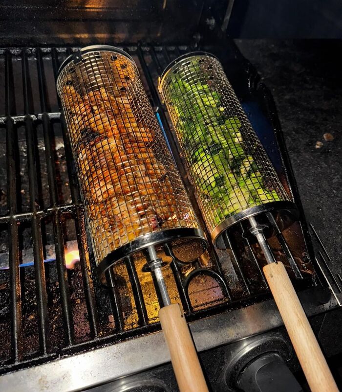Rotisserie-style grilling baskets with wooden handles cooking vegetables and meat on an outdoor grill, Amazon most wished for item.