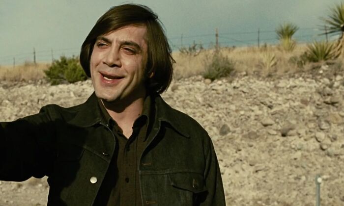 Actor Javier Bardem portraying a character in one of the new millennium's greatest films outdoors in a desert setting.