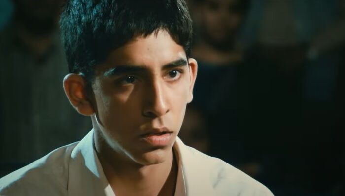 Close-up of a young man with short black hair, portraying a dramatic moment in one of the new millennium's greatest films.