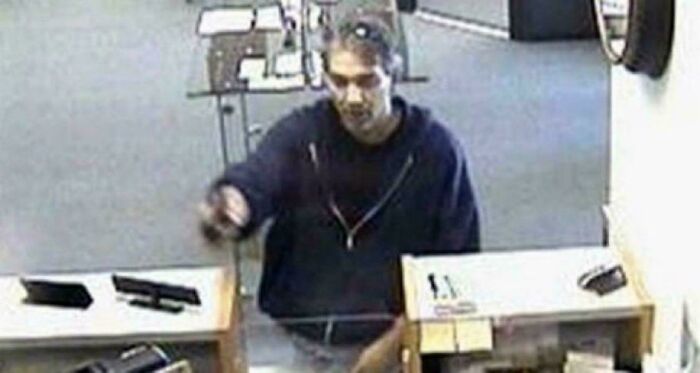 Man in a dark hoodie inside a store, captured on security camera as part of fascinating content on the internet facts.