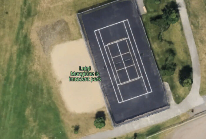 Aerial view of a tennis court and a dirt area in a park with a humorous Google Maps label showing shenanigans.