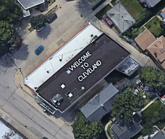 Aerial view of a building roof with a misspelled Welcome to Cleveland message, a Google Maps shenanigan captured.