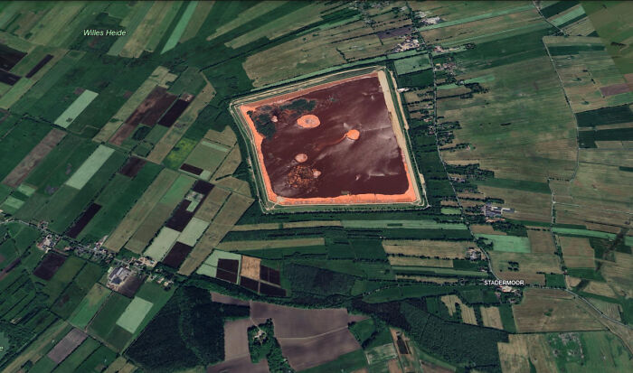 Aerial view of farmland with a large, irregularly shaped body of water showcasing shenanigans captured on Google Maps.