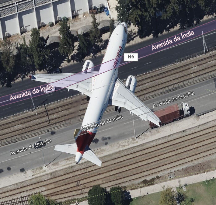 A plane captured on Google Maps parked across multiple streets and railway tracks, showing unusual shenanigans.