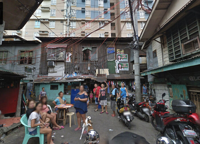 Group of people and parked motorcycles in an urban alley, showcasing unusual scenes captured on Google Maps.