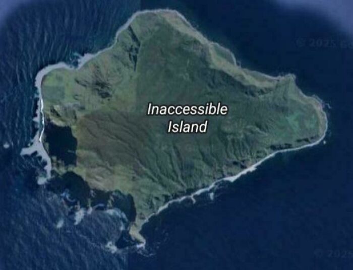 Aerial view of Inaccessible Island surrounded by ocean, one of the shenanigans captured on Google Maps.