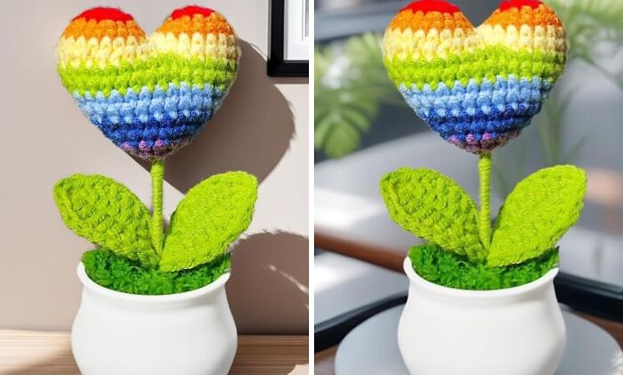 Crocheted rainbow heart-shaped flower with green leaves in a white pot, a colorful Pride piece for year-round celebration.