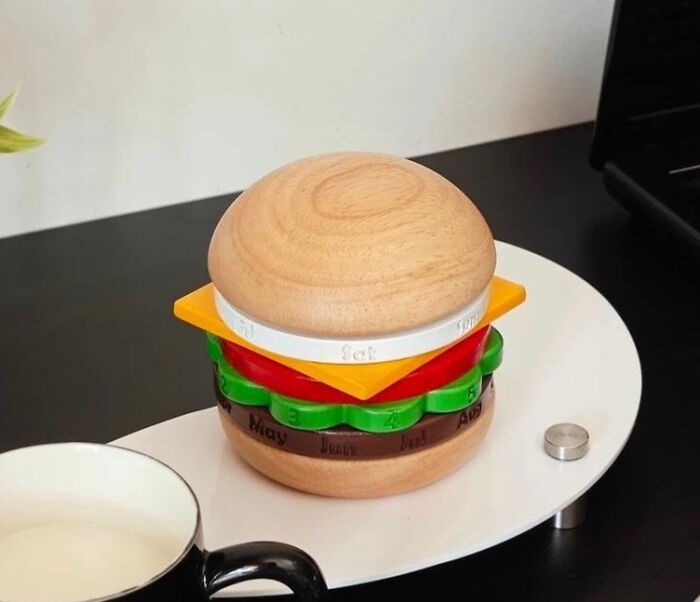Wooden desk accessory shaped like a hamburger with calendar features, ideal for making the 9-to-5 less blah.