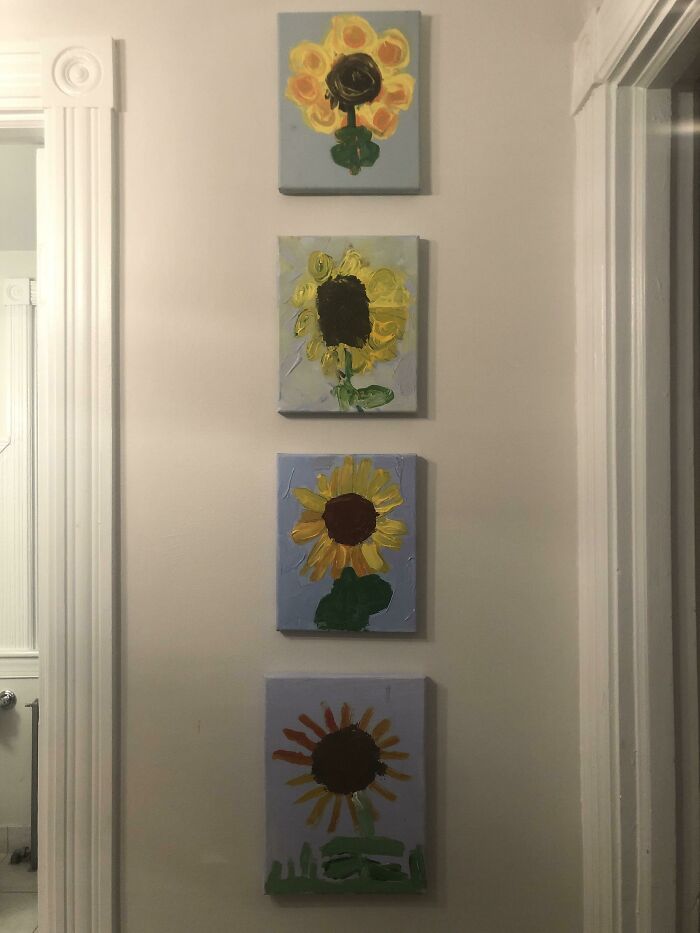 Four painted sunflower comparison pics hanging vertically on a wall, showcasing variety in flower art styles.
