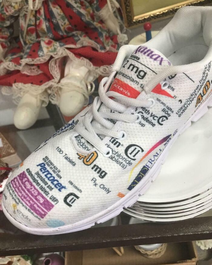 White sneaker covered in printed prescription medication labels, creating a funny and confusing visual effect.