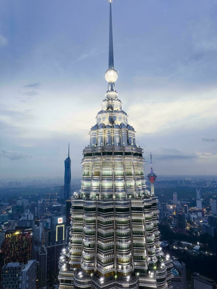 Illuminated view of a famous landmark from an unexpected angle, showcasing intricate architectural details at dusk.