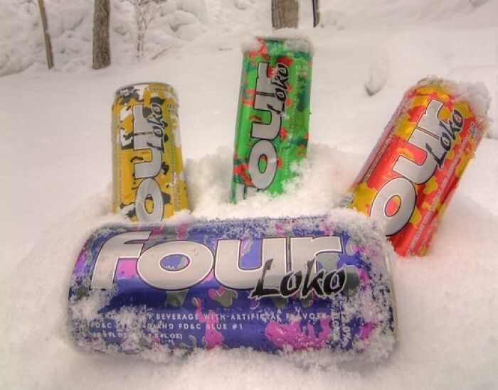Four Loko cans covered in snow outdoors, showing one of the surprising foods banned in the USA.